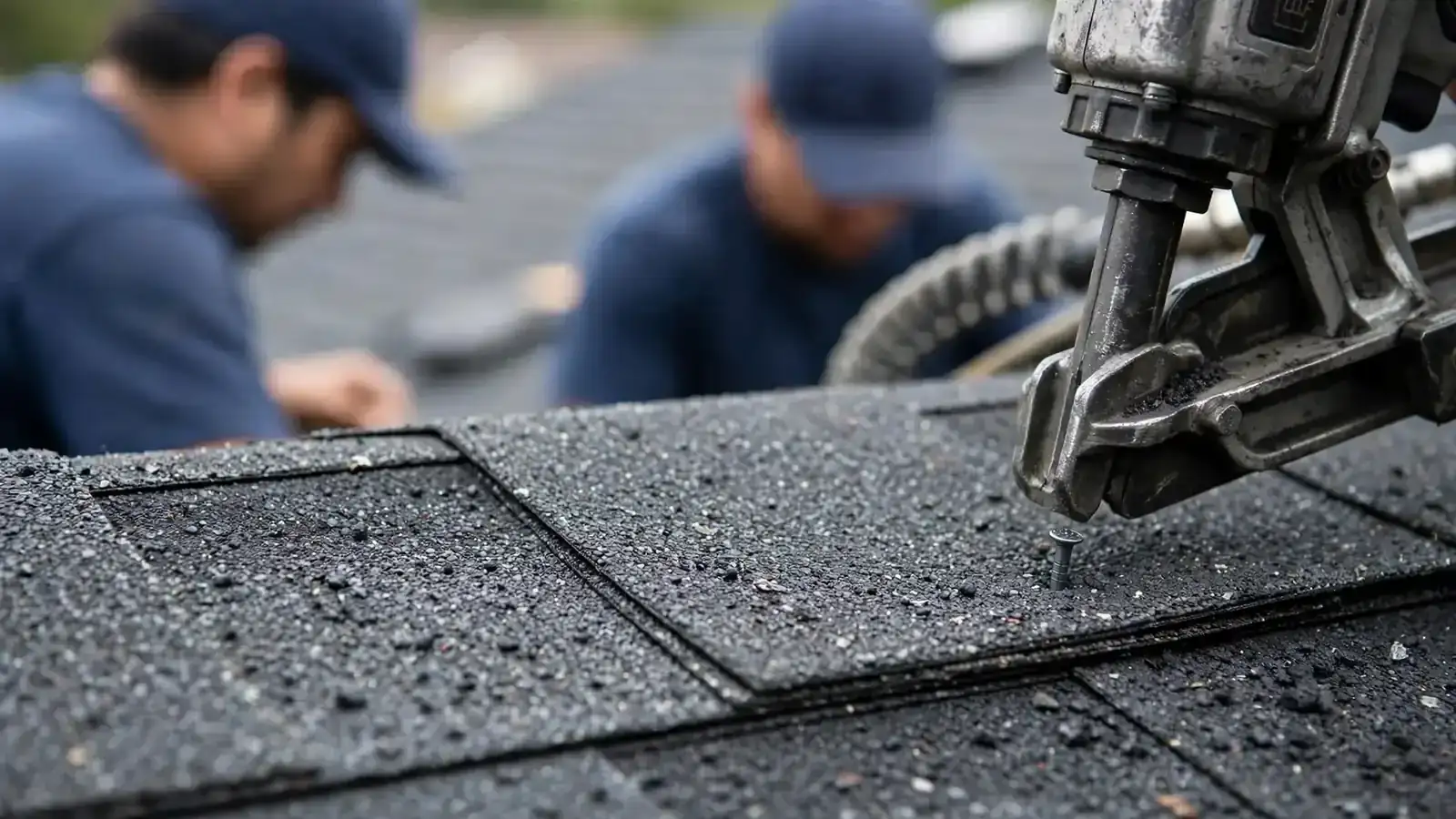 Close-up of impact-resistant shingles being nailed down